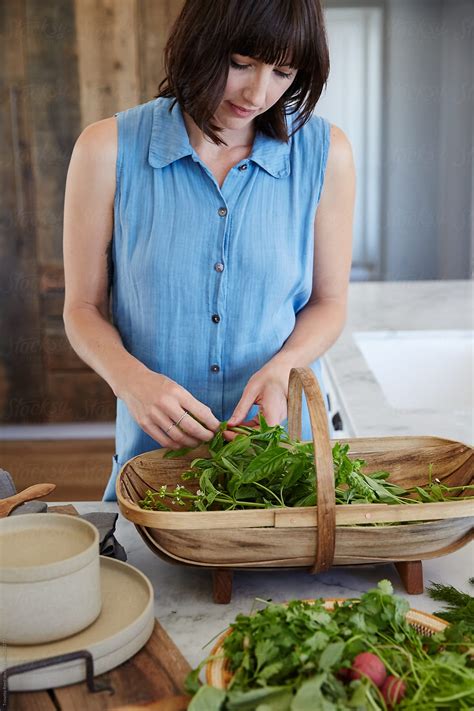Woman In Kitchen With Just Picked Fresh Basil Herbs Del Colaborador