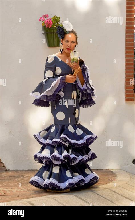 Spanish Woman Dressed In Traditional Flamenco Dress During Feria Of Mijas Andalucia Spain