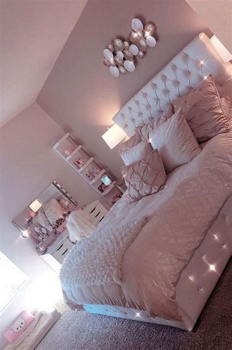 A Bedroom With A Large Bed And Lots Of Lights On The Headboard Is Shown