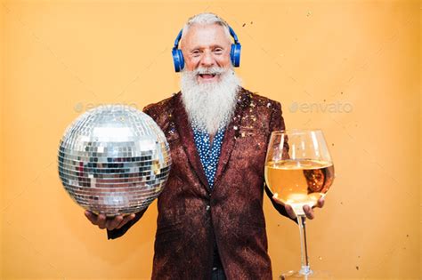 Crazy Senior Man Having Fun Celebrating New Year Eve Party Holding