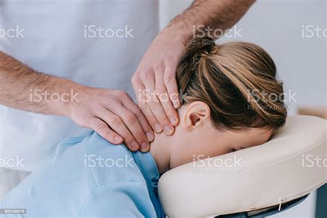 Closeup Shot Of Masseur Doing Neck Massage For Businesswoman Stock