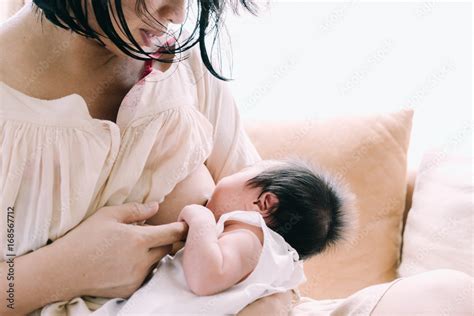 Mother Breastfeeding Her Newborn Baby Girl Stock Photo Adobe Stock