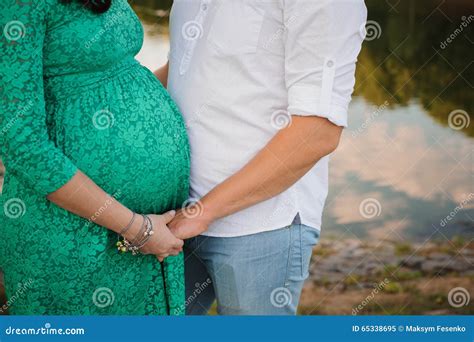 Pregnant Woman And Her Husband In Green Dress Stock Image Image Of Holiday Body 65338695