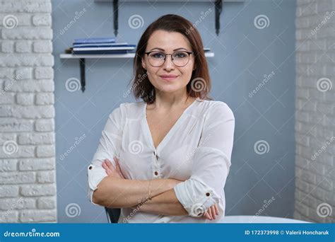Portrait Of Positive Confident Mature Woman With Folded Arms Stock Photo Image Of Business