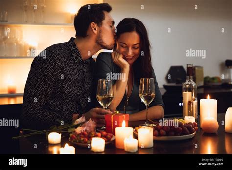 Beautiful Passionate Couple Having A Romantic Candlelight Dinner At