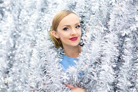 A Portrait Of Beautiful Caucasian Woman With Christmas Garland