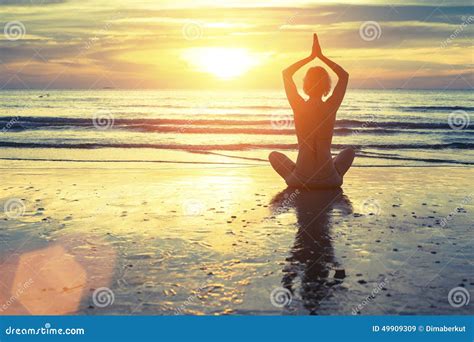 Silhouette Of Yoga Woman Meditating On The Ocean Beach Fitness Stock
