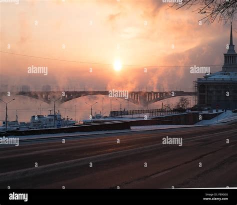Frosty Sunset With Steam From The River The City Of Krasnoyarsk