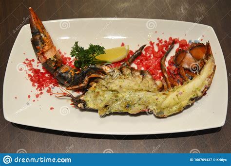 Baked Canadian Lobster With Cheese On Plate In Hotel Restaurant Stock