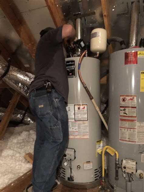 Shad is sweating like crazy installing these twin water heaters in the