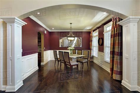 Dining Room In Luxury Home With Maroon Walls Stock Photo Dissolve