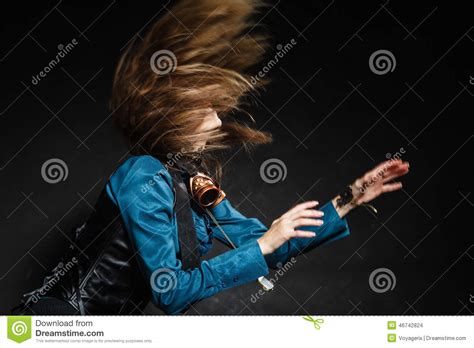Action Shot Of An Attractive Woman Swinging Her Hair Stock Photo