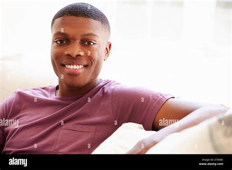 Portrait Of Young Man Relaxing Sitting On Sofa Stock Photo Alamy