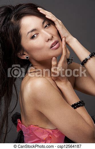 Asian Glamour Woman Beautiful Asian Brunette Wearing Jewellery And Fashin Dress On Dark Background