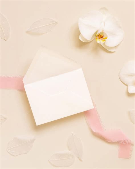 Premium Photo Wedding Envelope Near White Orchid Flower And Silk