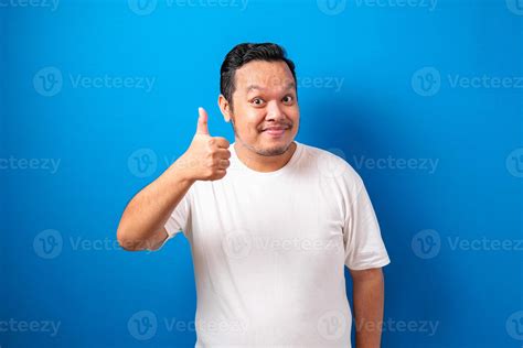 Fat Asian Guy Wearing A White T Shirt Smiles At The Camera While