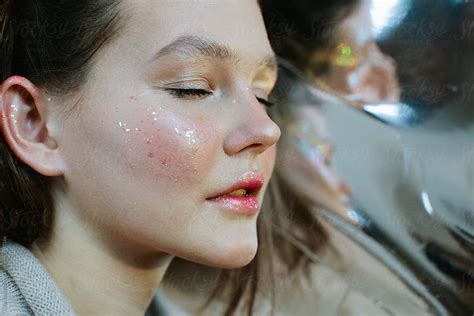Portrait Of Girl With Sparkling Glitter On Her Face By Stocksy