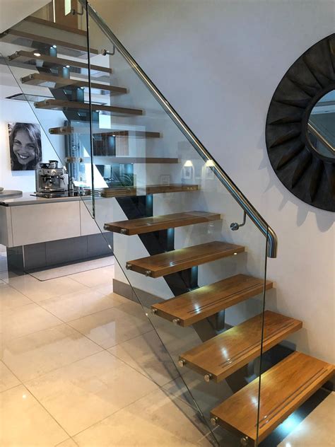 Steel & glass staircases at carter fabrications, we supply staircases and mezzanine floors, from single to multi level, for industrial and public sectors throughout the united kingdom. Feature central spine staircase with solid Oak treads and glass balustrade | Taylorhood ...
