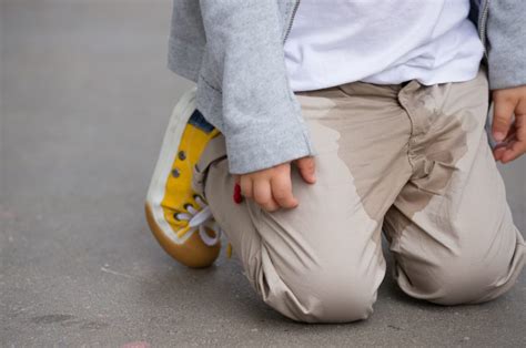 A Young Kid Peeing On His Pants On The Street Bed Wetting Concept