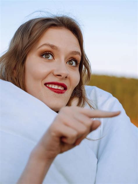 Surprised Lady Wrapped In A Blanket Pointing At Free Space Excited