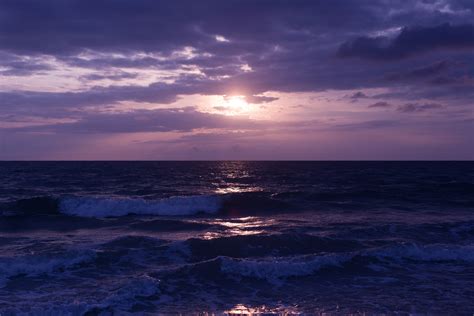 Photo Of Blue Ocean And Dark Clouds During Sunset · Free Stock Photo