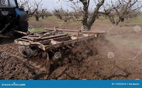 Tractor Cultivating The Ground With A Disc Harrow In The Fruit Garden Stock Footage Video Of