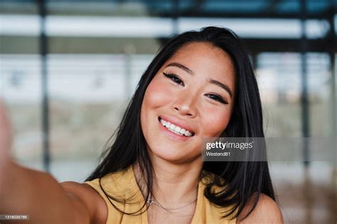 Female Professional Taking Selfie At Office High Res Stock Photo