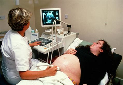 Ultrasound Scanning Of A Pregnant Womans Abdomen Photograph By Antonia Reevescience Photo