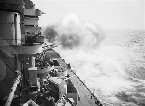 The 16 Inch Guns On The Battleship Hms Rodney Open Fire During A