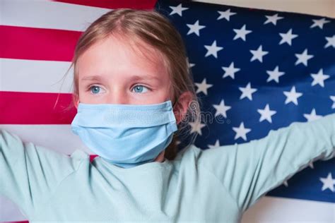 Young Blonde Girl Wearing Protection Mask With American Usa Flag