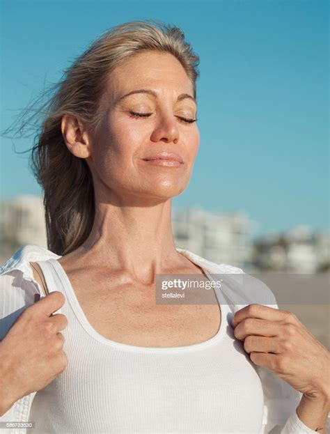 Woman Inhaling Fresh Air At The Beach Photo Getty Images