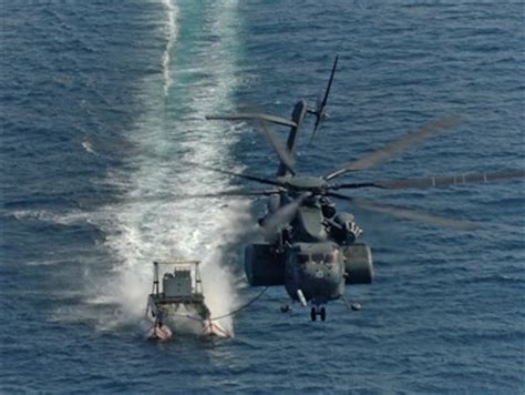 A Us Navy Mh 53e Sea Dragon Helicopter Pulls An Mk 105 Minesweeping Sled