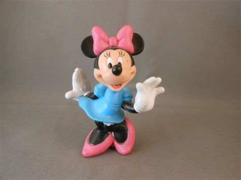 Minnie Is Standing Doing A Curtsy She Has On A Baby Blue Dress A Pink