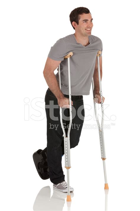 Injured Man Walking With The Help Of Crutches Stock Photo Royalty
