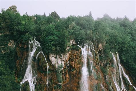 Rocky Ravine With Rapid Waterfall Under Overcast Sky · Free Stock Photo