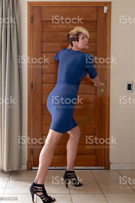 40 Something Woman With Blue Dress Trap In A House Back And Side View