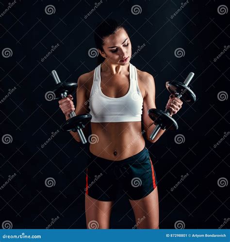Athletic Young Woman Doing A Fitness Workout Against Black Background