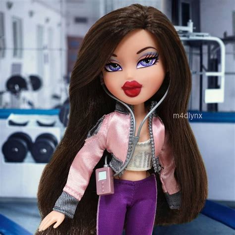 A Close Up Of A Doll With Long Brown Hair And Purple Pants Wearing A