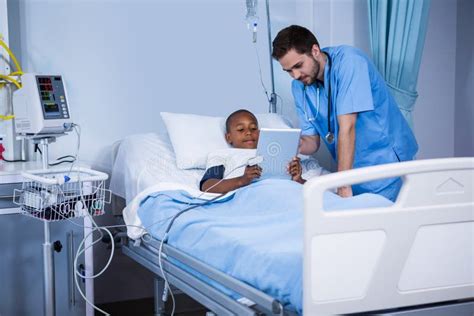 Male Nurse And Patient Using Digital Tablet In Ward Stock Photo Image