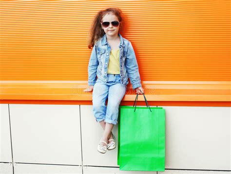 Pretty Little Girl Child Wearing A Jeans Clothes With Shopping Bags