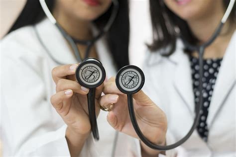 Two Female Doctors Holding Black Stethoscopes Doctor Team Piqsels