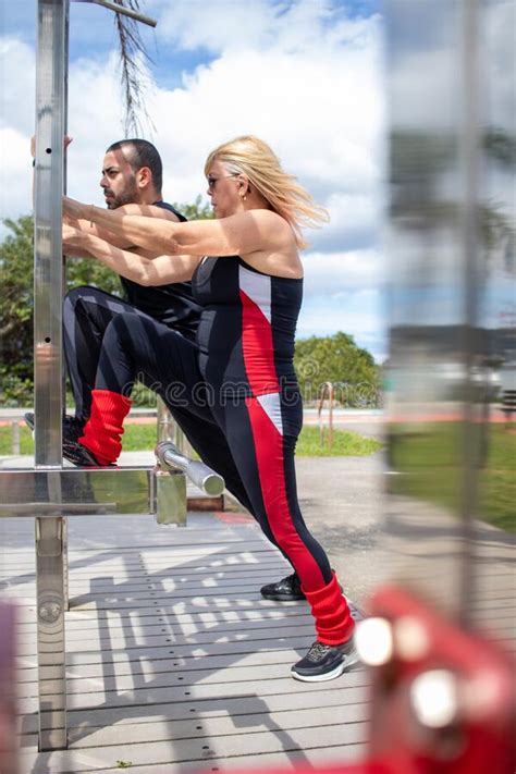 Blonde Lady Exercising With Her Personal Trainer Stock Image Image Of