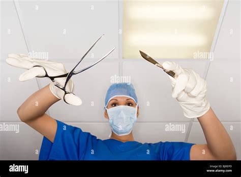 Surgeon with scalpel and clamp Stock Photo - Alamy