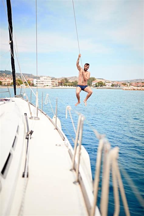 Man Jumping From Sailing Boat In Sea Stock Image Image Of Sailing