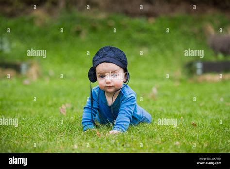 6 Month Old Baby Crawling Outside In Green Grass Stock Photo Alamy