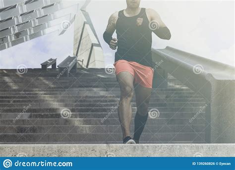 Muscular Hispanic Young Male Dark Skinned Athlete Running Up A Flight