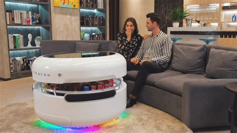 The coosno smart coffee table has a glowing led table top to put on a show while you listen to music through its bluetooth speakers. Coosno, une table basse futuriste avec frigo intégré - NeozOne
