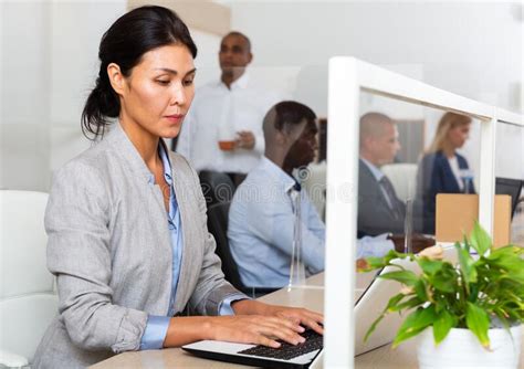 Focused Asian Woman Entrepreneur Working With Laptop In Office Stock
