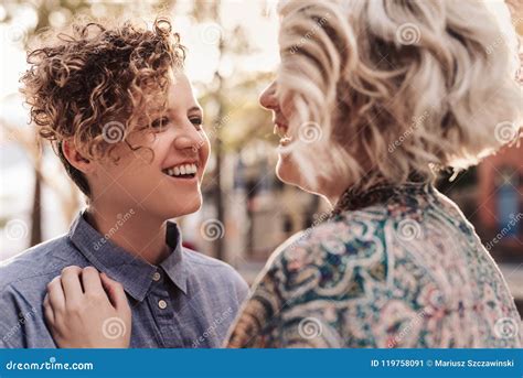 Laughing Young Lesbian Couple Standing Together Outside In The City