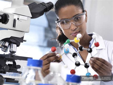 Biotechnology Research Female Scientist Examining A Chemical Formula